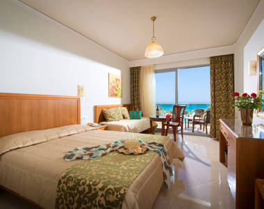 Ariadne Hotel Malia Luxury Room double bed, couch, amenities and balcony view