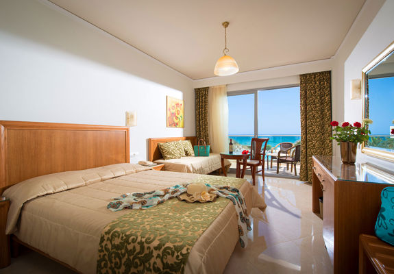 Ariadne Hotel Malia Luxury Room double bed, couch, amenities and balcony view