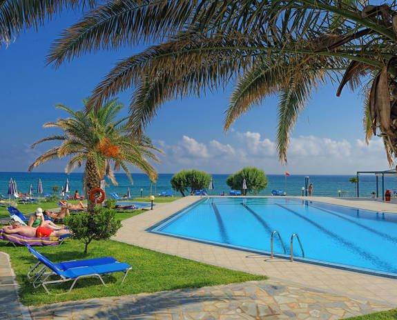 Ariadne Hotel Malia pool view with sunbeds on grass