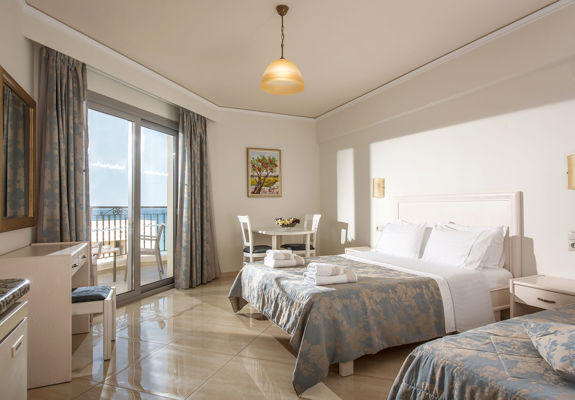 Ariadne Hotel Malia Studio double bed, table with two chairs, balcony view and amenities