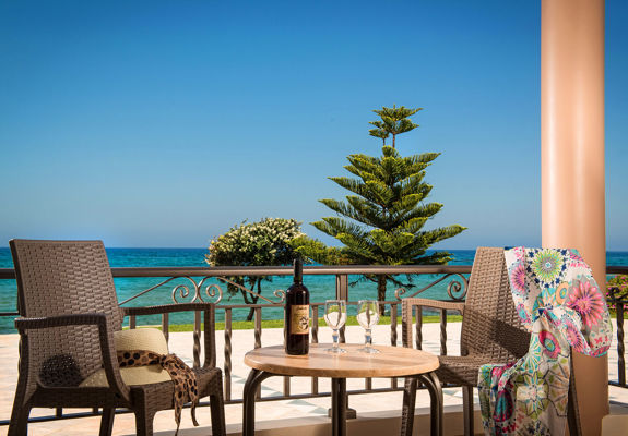 Ariadne Hotel Malia Luxury Studio balcony with two chairs, table with a bottle and two glasses of wine and sea view