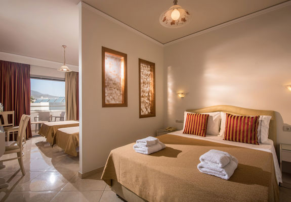 Ariadne Hotel Malia Family Room double bed and two single beds on the other side of a wall